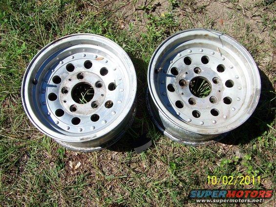 Two aluminum rims with multiple bolt holes