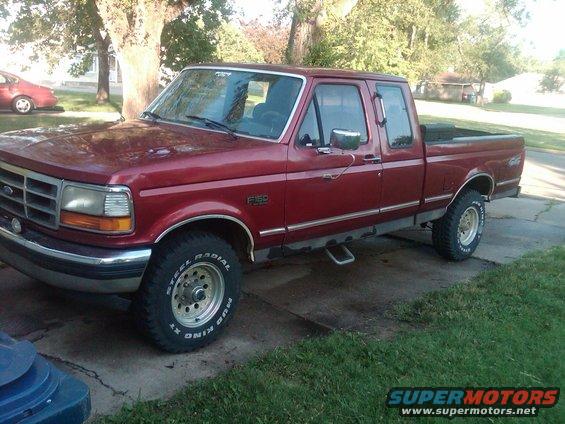 Red 1992 Ford F-150 crew cab pickup truck parked on a driveway