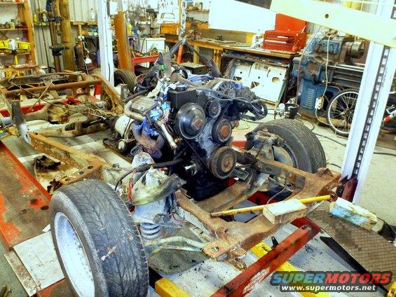 Vehicle chassis and engine assembly in a workshop