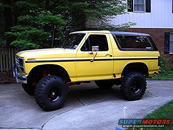 Yellow lifted 1985 Ford Bronco parked on driveway