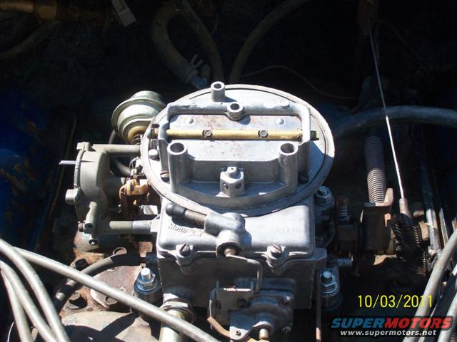 Carburetor with visible "Motorcraft" text, in engine bay
