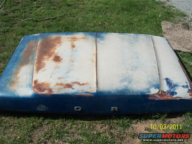 Blue and white hood with rust, showing 'FORD' lettering