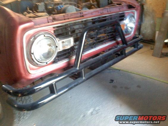 Red 1978 Ford Bronco front end with a black bull bar and grille