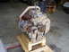 1992 Ford Bronco - Engine assembly with turbocharger and drive belts, mounted on a wooden pallet for transport or storage.