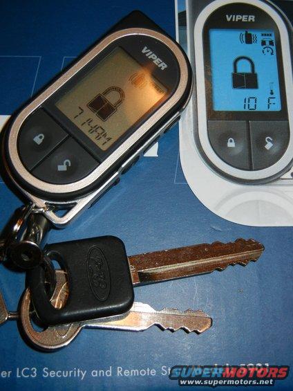 Two Viper car remotes and Ford keys on a blue surface