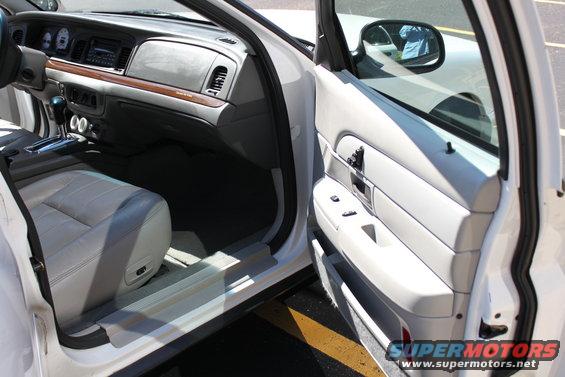 White 2003 Ford Crown Victoria interior, showing dashboard and door panel