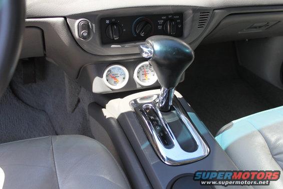Interior dashboard with oil and voltage gauges and automatic gear shifter