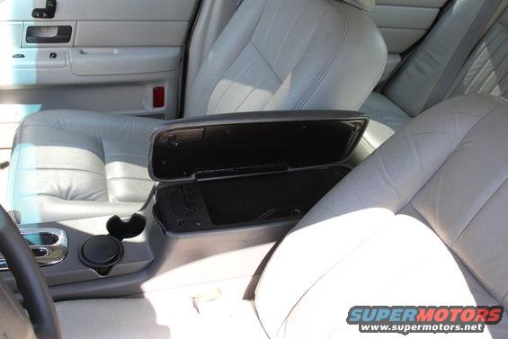 2003 Ford Crown Victoria interior showing front seats, center console with open armrest, and part of the steering wheel