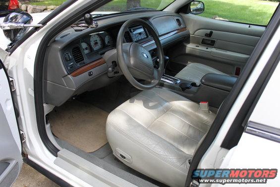 Interior of a 2003 Ford Crown Victoria, showing the dashboard, steering wheel, and front seats