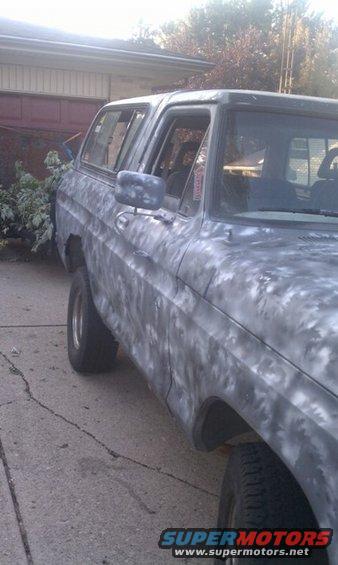 1978 Ford Bronco with primer paint job, viewed from the side