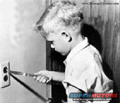 Child inserting knife into electrical outlet