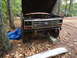 1985 Ford Bronco - A Ford Bronco from the early 1980s sits outdoors with its hood raised, awaiting repairs or parts.