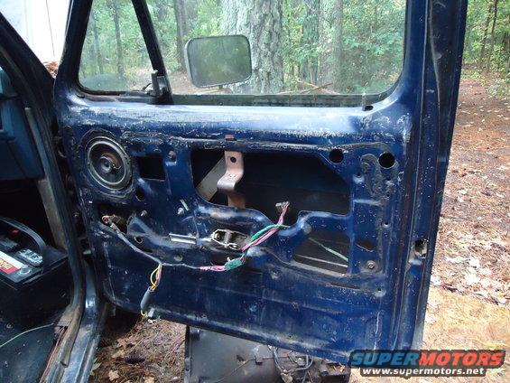 Blue door interior with speaker and exposed wiring
