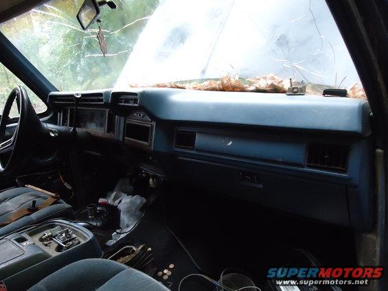 1985 Ford Bronco interior with cracked windshield and worn seats