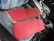 1985 Ford Bronco - The interior of a vehicle shows two red sun visors placed on the seats.