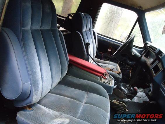 Blue velour seats and dashboard of an older truck, viewed from the passenger side