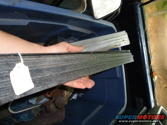 Hands holding stacked metal trim pieces with a white tag attached