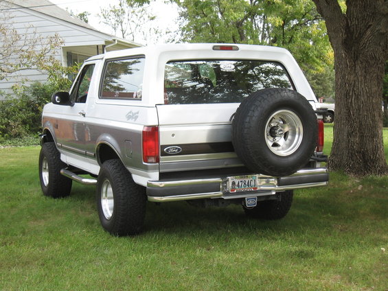 1994 Ford Bronco with spare tire mounted on rear door, silver and grey two-tone paint