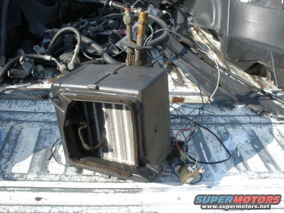 car heater core assembly with hoses and wires, sitting in a truck bed