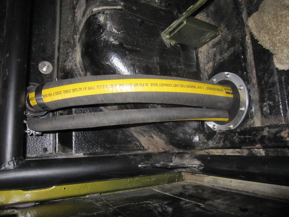 1-1/4" marine fuel/wet exhaust hose with yellow stripe, installed through a metal flange