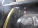 1974 Ford Bronco - A hose connects to a fuel filler neck assembly, showing visible text on the hose.