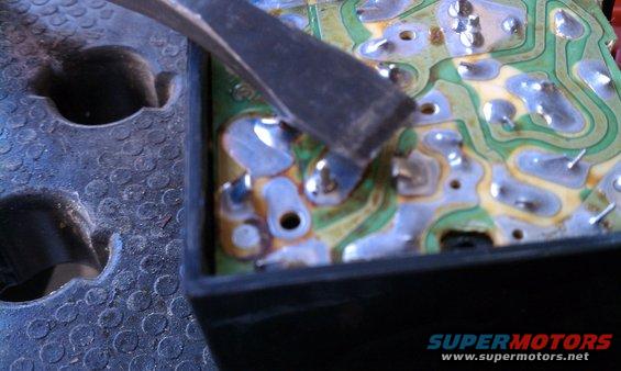 Circuit board with tool being used on solder points