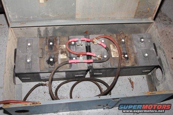 Four vehicle batteries wired together in a metal enclosure