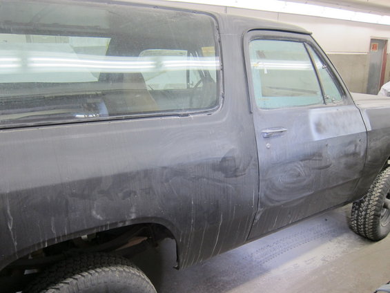 Black Dodge Ramcharger side view, dusty, showing rear fender and door