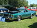1977 Ford Ranchero - A green 1977 Ford Ranchero is displayed with its hood up at an outdoor event.