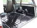 1996 Ford Bronco - The interior cargo area of a 1996 Ford Bronco shows a freshly applied black bed liner.