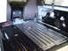 1996 Ford Bronco - The interior of a vehicle is being worked on, with the floor stripped and painted blacked out.