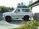 1996 Ford Bronco - Side view of a white Ford Bronco parked on a driveway.