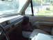 1996 Ford Bronco - Interior view of a 1992 Ford F-150, revealing its tan dashboard, door panel, and seating area.