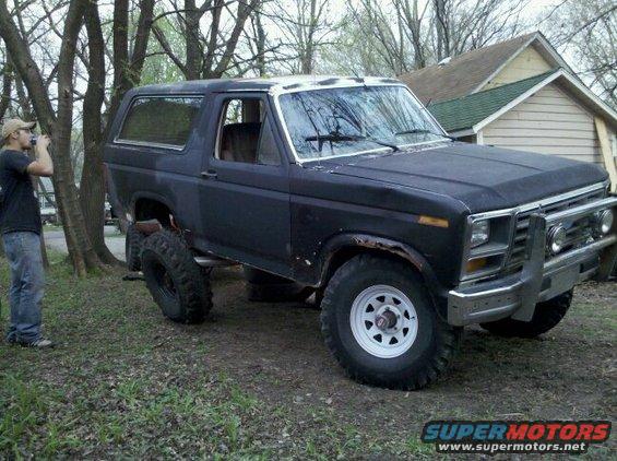 Black Ford Bronco with lifted suspension and off-road tires parked outdoors