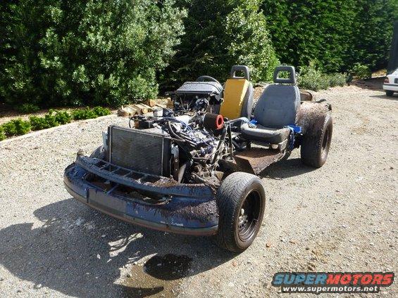 Custom vehicle project with exposed engine and two seats, front view