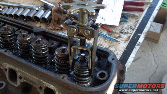 20111016_154848_315.jpg spring compressor tool. tighten it down and then pop out valve locks.