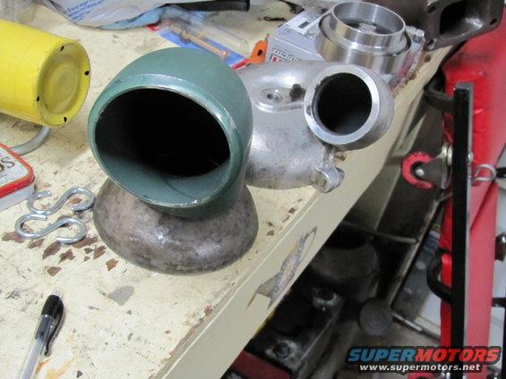 Green intake hat and turbocharger parts on a workbench