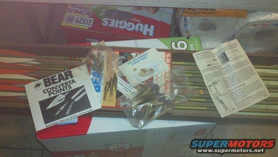 Box of archery arrows and arrowheads, with packaging and instructions