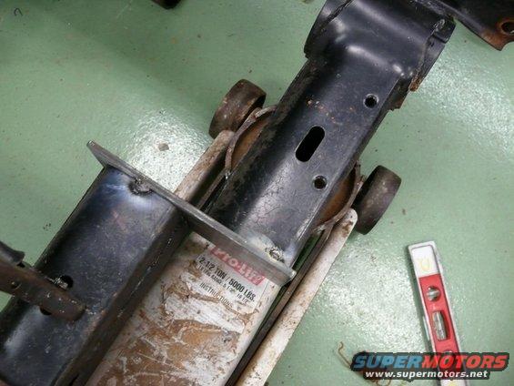 Car jack with "PRO-LIFT 2-1/2 TON / 5000 LBS" label, next to a spirit level