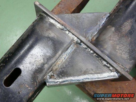 Close-up of welded metal frame with Supermotors.net watermark