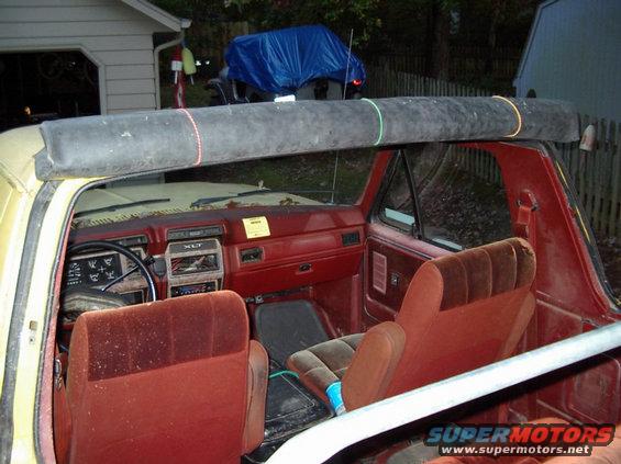 Rubber top neatly rolled up and held in place with miniature bungy cords.