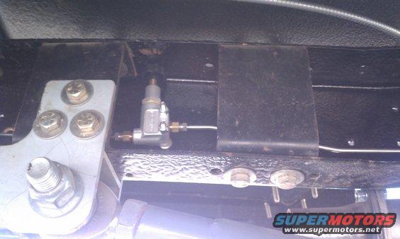 Close-up of a brake proportioning valve mounted to a vehicle's frame