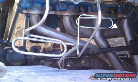 Close-up of engine exhaust manifolds and metal tubing