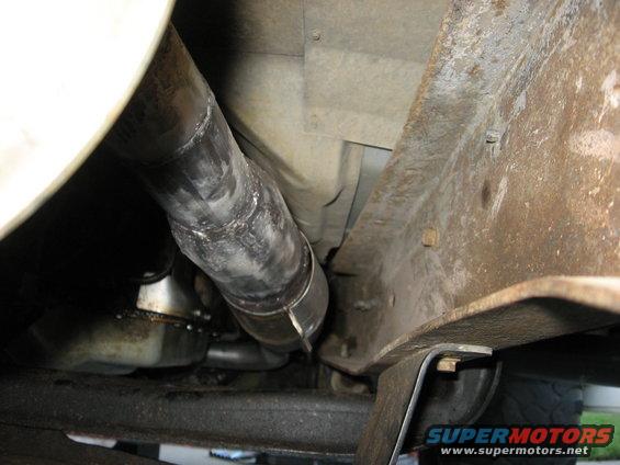 Close-up of an exhaust pipe connected to a vehicle's frame