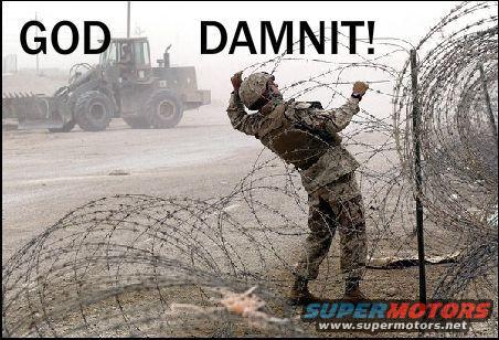 Soldier entangled in barbed wire, bulldozer in background