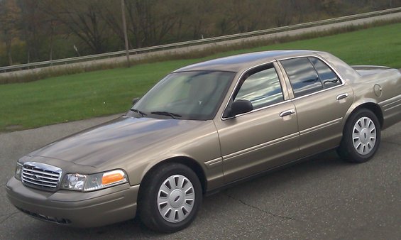 Tan 2007 Ford Crown Victoria sedan, 3/4 front view