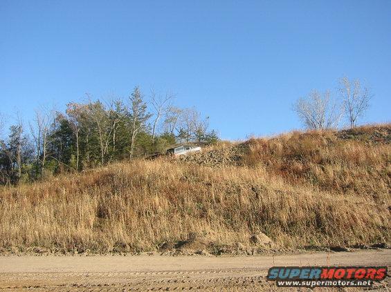 White 1991 Ford Bronco parked on a dry, grassy hillside