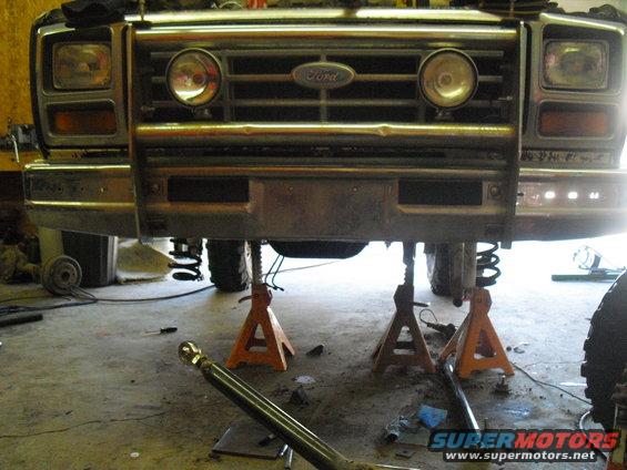 Front of Ford Bronco on jack stands, grille visible