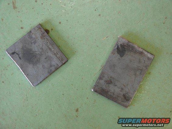 Two rectangular metal plates on a green surface