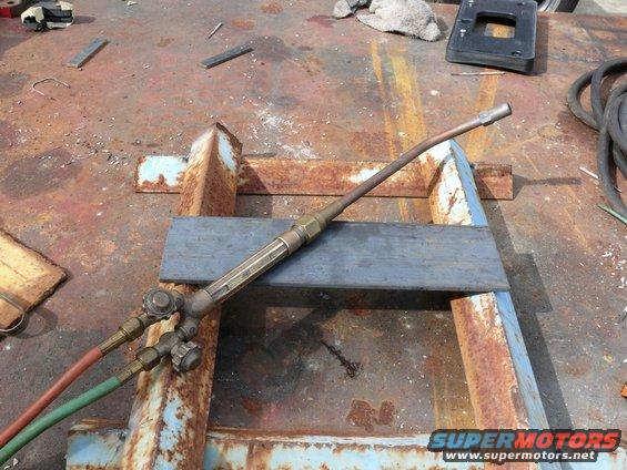 oxy-acetylene cutting torch on a rusty metal surface